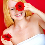 portrait of a young beautiful blonde girl with white flower