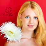 portrait of a young beautiful blonde girl with white flower