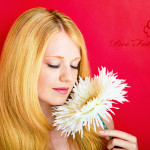 portrait of a young beautiful blonde girl with white flower