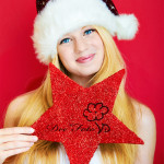 beautiful blonde woman holding a christmas gift is smiling