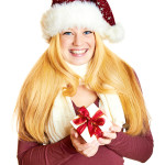 beautiful blonde woman holding a christmas gift is smiling