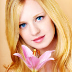 portrait of a young beautiful blonde girl with flower