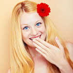 portrait of a young beautiful blonde girl with flower