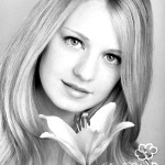 portrait of a young beautiful blonde girl with white flower