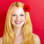 portrait of a young beautiful blonde girl with white flower